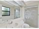 Clean bathroom with shower/tub combo, vanity, and palm tree accents at 13340 Country Club Dr, Tavares, FL 32778