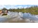 Peaceful waterfront view with lush vegetation and calm water at 13340 Country Club Dr, Tavares, FL 32778