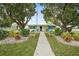 Community clubhouse with landscaping and walkway at 13340 Country Club Dr, Tavares, FL 32778