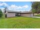Single story home with attached garage and landscaping at 13340 Country Club Dr, Tavares, FL 32778