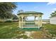 Lakeside gazebo with seating and water views at 13340 Country Club Dr, Tavares, FL 32778
