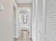 Hallway with linen closet and bathroom access at 13340 Country Club Dr, Tavares, FL 32778