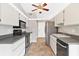 Galley kitchen with stainless steel appliances at 13340 Country Club Dr, Tavares, FL 32778