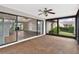 Spacious screened porch with sliding doors opening to living area and backyard at 13340 Country Club Dr, Tavares, FL 32778