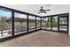 Bright screened porch overlooking a canal with boat dock and lush greenery at 13340 Country Club Dr, Tavares, FL 32778