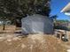 Gray metal garage with roll-up door at 15 Dogwood Trail Ter, Ocala, FL 34472