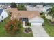 Single-story home with a large yard, driveway, and attached garage at 17848 Se 87Th Bourne Ave, The Villages, FL 32162