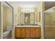 Double vanity bathroom with wood cabinets and a shower at 17848 Se 87Th Bourne Ave, The Villages, FL 32162