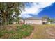 Spacious backyard with shed and mature trees at 202 Forest Park Ln, Lady Lake, FL 32159