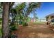 Landscaped backyard, featuring a shed and lush greenery at 202 Forest Park Ln, Lady Lake, FL 32159