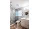 Updated bathroom with marble shower, white vanity, and modern fixtures at 202 Forest Park Ln, Lady Lake, FL 32159