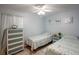 Bright bedroom with twin beds, dresser, and ceiling fan at 202 Forest Park Ln, Lady Lake, FL 32159