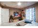 Bright bedroom with gaming setup and a comfortable bed at 202 Forest Park Ln, Lady Lake, FL 32159
