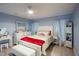 Main bedroom with white furniture and red bedding at 202 Forest Park Ln, Lady Lake, FL 32159