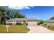 Cute one-story house with a two-car garage and nicely landscaped lawn at 202 Forest Park Ln, Lady Lake, FL 32159