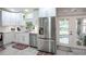 Updated kitchen with stainless steel appliances and white cabinets at 202 Forest Park Ln, Lady Lake, FL 32159
