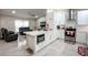 Open concept kitchen with island, stainless steel appliances, and white cabinets at 202 Forest Park Ln, Lady Lake, FL 32159