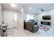 Spacious living room with gray couches and a large TV at 202 Forest Park Ln, Lady Lake, FL 32159