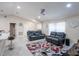 Relaxing living room with gray reclining sofas and a large TV at 202 Forest Park Ln, Lady Lake, FL 32159