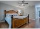 Bedroom with wood bed frame, ceiling fan, and closet at 2247 Cypress Cove Dr # E2, Tavares, FL 32778