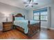 Bedroom with wooden bed frame, light blue bedding, and ceiling fan at 2247 Cypress Cove Dr # E2, Tavares, FL 32778