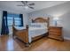 Bedroom with wood bed frame and ceiling fan at 2247 Cypress Cove Dr # E2, Tavares, FL 32778