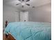 Bedroom with wooden bed frame, light blue bedding, and ceiling fan at 2247 Cypress Cove Dr # E2, Tavares, FL 32778