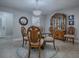 Elegant dining room with glass-top table and wooden chairs at 2247 Cypress Cove Dr # E2, Tavares, FL 32778