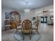 Bright dining room features a glass-top table, four chairs, and a china cabinet at 2247 Cypress Cove Dr # E2, Tavares, FL 32778