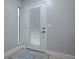 Light grey entryway with white door and rug at 2247 Cypress Cove Dr # E2, Tavares, FL 32778