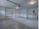 Attached garage offers storage shelving and extra space for car and items at 2247 Cypress Cove Dr # E2, Tavares, FL 32778