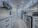 Modern kitchen with white shaker cabinets and stainless steel appliances at 2247 Cypress Cove Dr # E2, Tavares, FL 32778