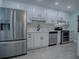 Updated kitchen boasts stainless steel appliances and white shaker cabinets at 2247 Cypress Cove Dr # E2, Tavares, FL 32778