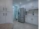 Modern kitchen with white cabinets, stainless steel appliances and view to dining area at 2247 Cypress Cove Dr # E2, Tavares, FL 32778