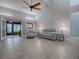 Spacious living room with grey couch and access to a screened porch at 2247 Cypress Cove Dr # E2, Tavares, FL 32778