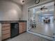 Outdoor wet bar with granite countertop and mini-fridge at 2247 Cypress Cove Dr # E2, Tavares, FL 32778