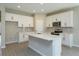 Modern kitchen with white cabinets, tile backsplash, and an island at 2827 Supermarine Rd, Tavares, FL 32778