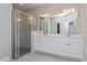 Bathroom boasts double vanity, a large mirror, and a walk-in shower at 2878 Supermarine Rd, Tavares, FL 32778