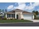 One-story home with a two-car garage and landscaped lawn at 2878 Supermarine Rd, Tavares, FL 32778