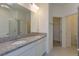 Bathroom with granite countertop, double sinks, and separate shower at 2992 Supermarine Rd, Tavares, FL 32778