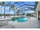 Inviting screened pool with water features and lake view at 2994 Luraville Rd, The Villages, FL 32163