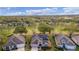 Aerial view of house on golf course with a view of other homes nearby at 3614 Kingswood Ct, Clermont, FL 34711