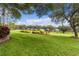 Landscaped backyard with a lush lawn and neighborhood view at 3614 Kingswood Ct, Clermont, FL 34711