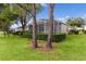 Screened patio and lush landscaping in the backyard at 3614 Kingswood Ct, Clermont, FL 34711