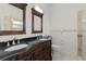 Elegant bathroom with double vanity and dark countertop at 3614 Kingswood Ct, Clermont, FL 34711