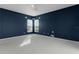 Bright bedroom with two windows and dark blue walls at 3614 Kingswood Ct, Clermont, FL 34711