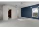 Spacious bedroom with walk-in closet and blue accent wall at 3614 Kingswood Ct, Clermont, FL 34711