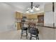 Kitchen with granite countertops, light wood cabinets, and breakfast bar at 3614 Kingswood Ct, Clermont, FL 34711