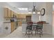 Kitchen with granite countertops, light wood cabinets, and breakfast bar at 3614 Kingswood Ct, Clermont, FL 34711