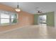 Living room with tile floors, sliding glass doors, and ceiling fan at 3614 Kingswood Ct, Clermont, FL 34711